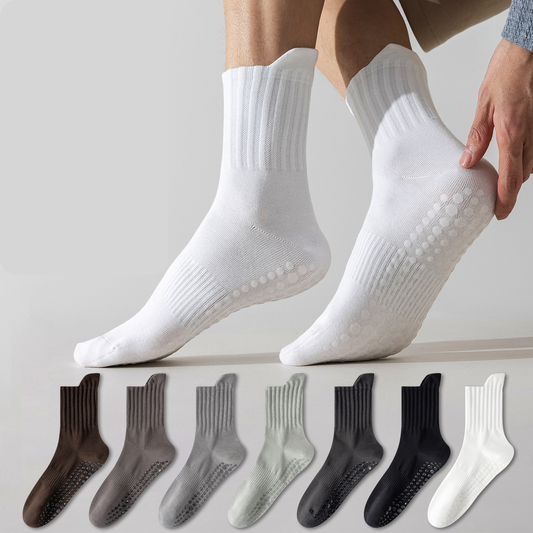White socks with textured sole worn by a person, with color swatches below on a light gray background.