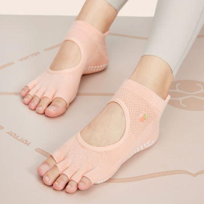 A pair of brown toeless non-slip grip socks with a pattern of white circles on the sole and a red cherry on the ankle support band.